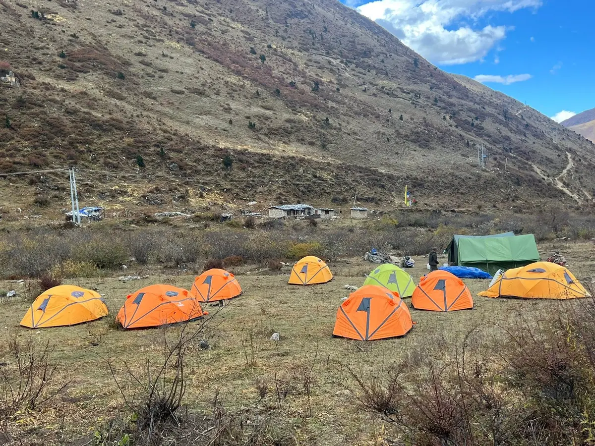 Bhutanese high-altitude trekking camp — operators supply tents, sleeping bags, dining tent, and kitchen crew for all multi-day routes