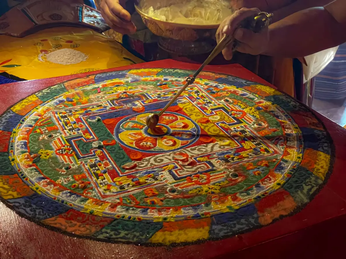Bhutanese meditation practitioners sitting in contemplation inside a mountain monastery — the spiritual practice at the core of Gross National Happiness
