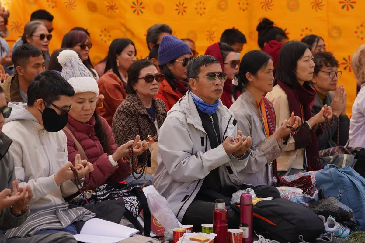 Buddhist meditation practitioner sitting before sacred Vajrayana symbols in a Bhutanese monastery