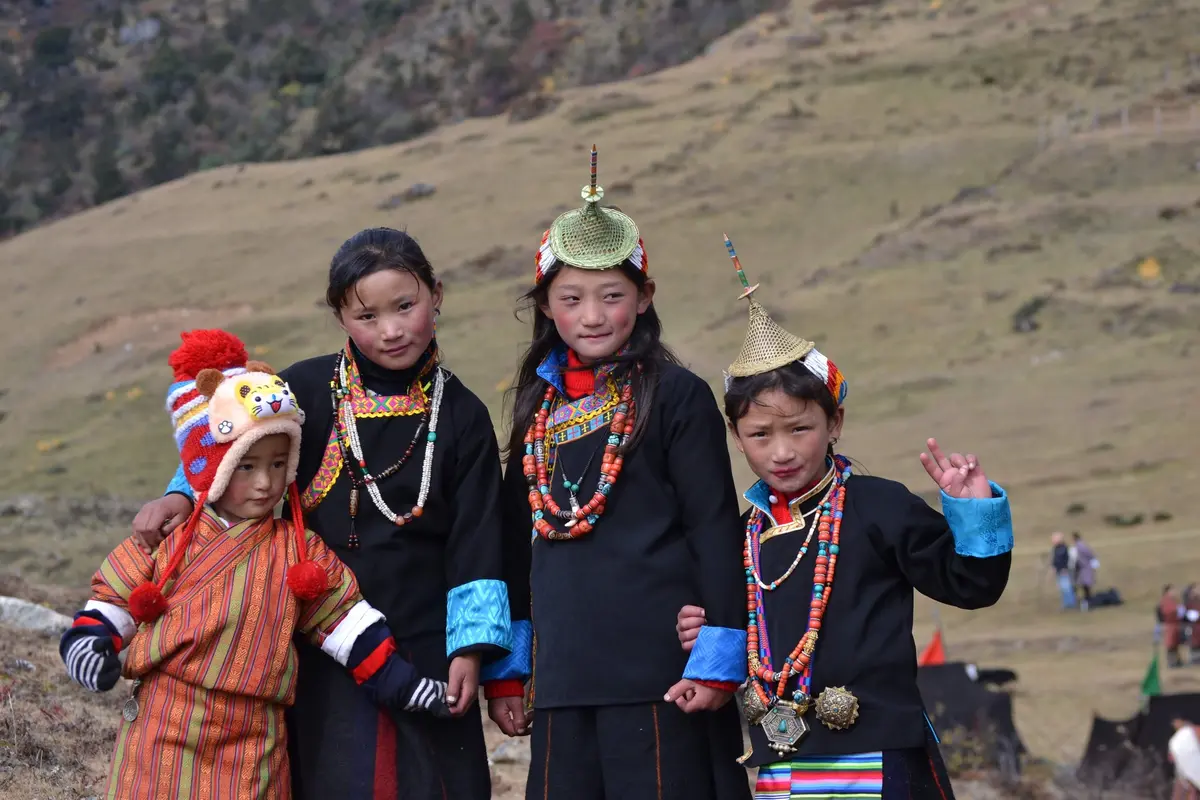 Children from the Laya community in traditional bamboo hats — the Laya-Gasa trek passes through one of Bhutan's most isolated villages