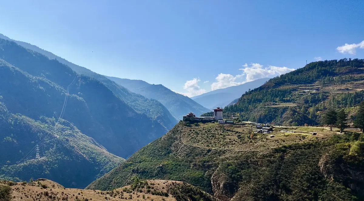 Dobji Dzong rising above a river gorge in western Bhutan — one of the kingdom's finest examples of traditional fortress architecture built without nails