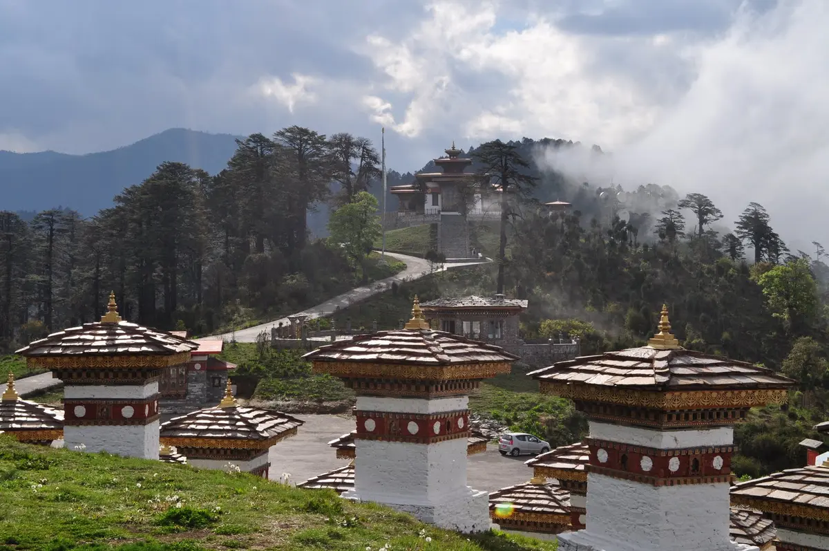 The road through the Dochula Pass with its 108 chortens — once your visa is stamped, all of this is open to you