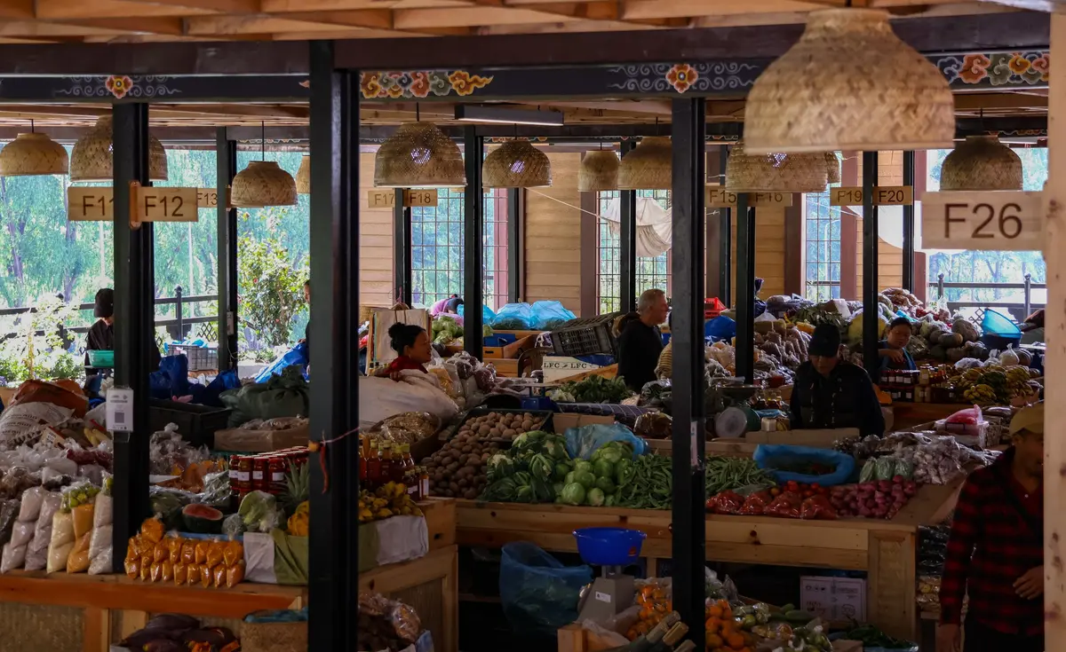Bhutanese farmers selling local produce including chilies, seasonal vegetables and traditional foods at an outdoor market