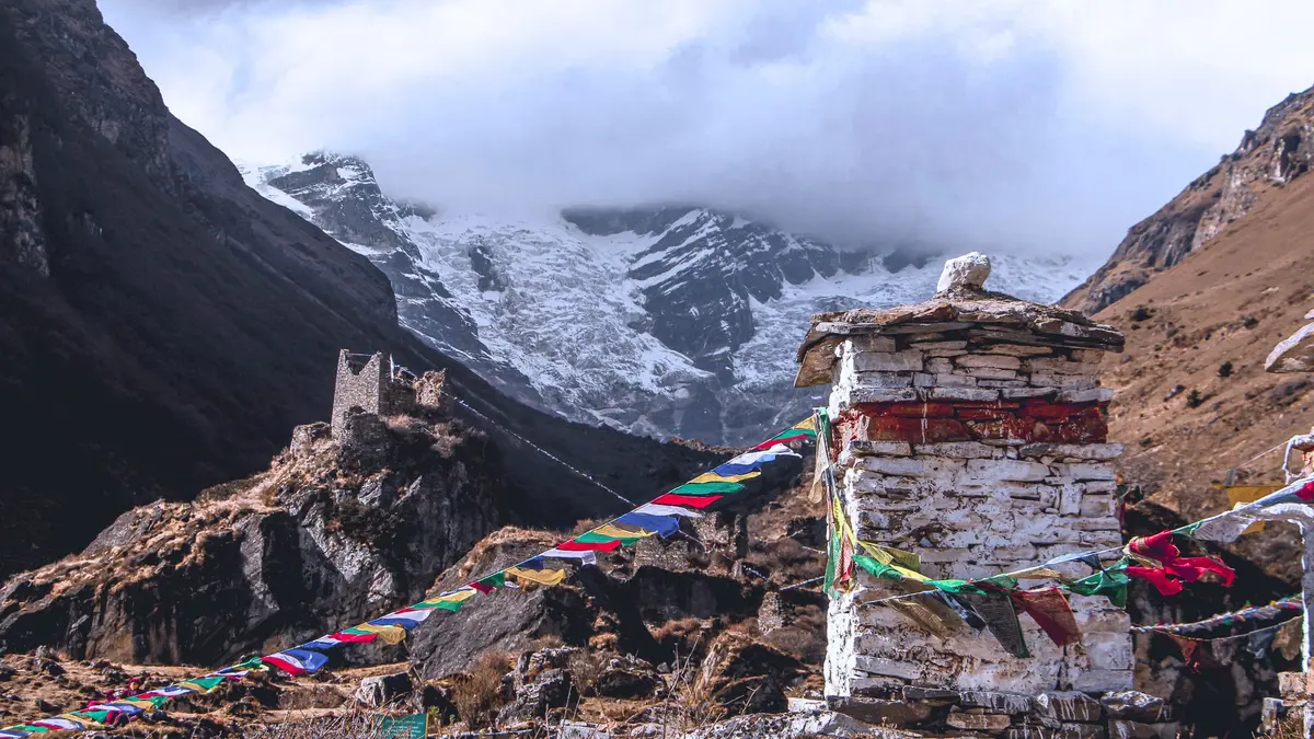 Jomolhari peak (7,326m) rising above a prayer flag chorten on the approach to Jangothang base camp